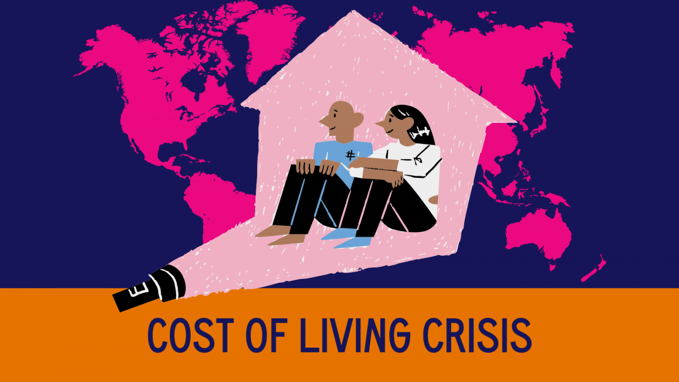 Cost of living crisis. An illustration of two people sitting in a house which is lit up by a torch. There is world map in the background. 